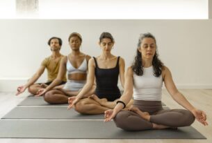 yoga-students-meditate-in-a-modern-studio-2024-05-13-23-47-42-utc